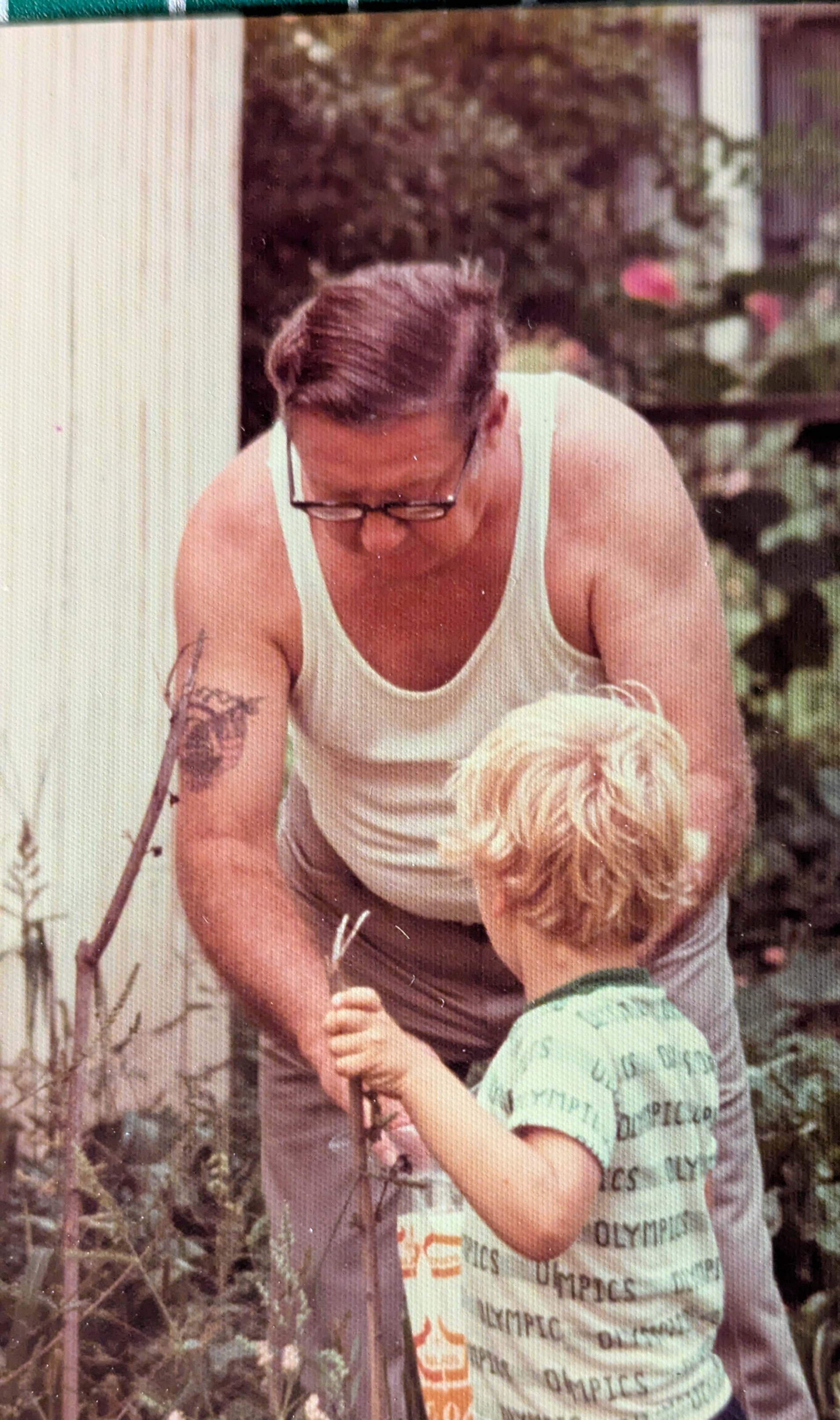 Grandpa Vernon Douglas Wood with young Justin in the garden